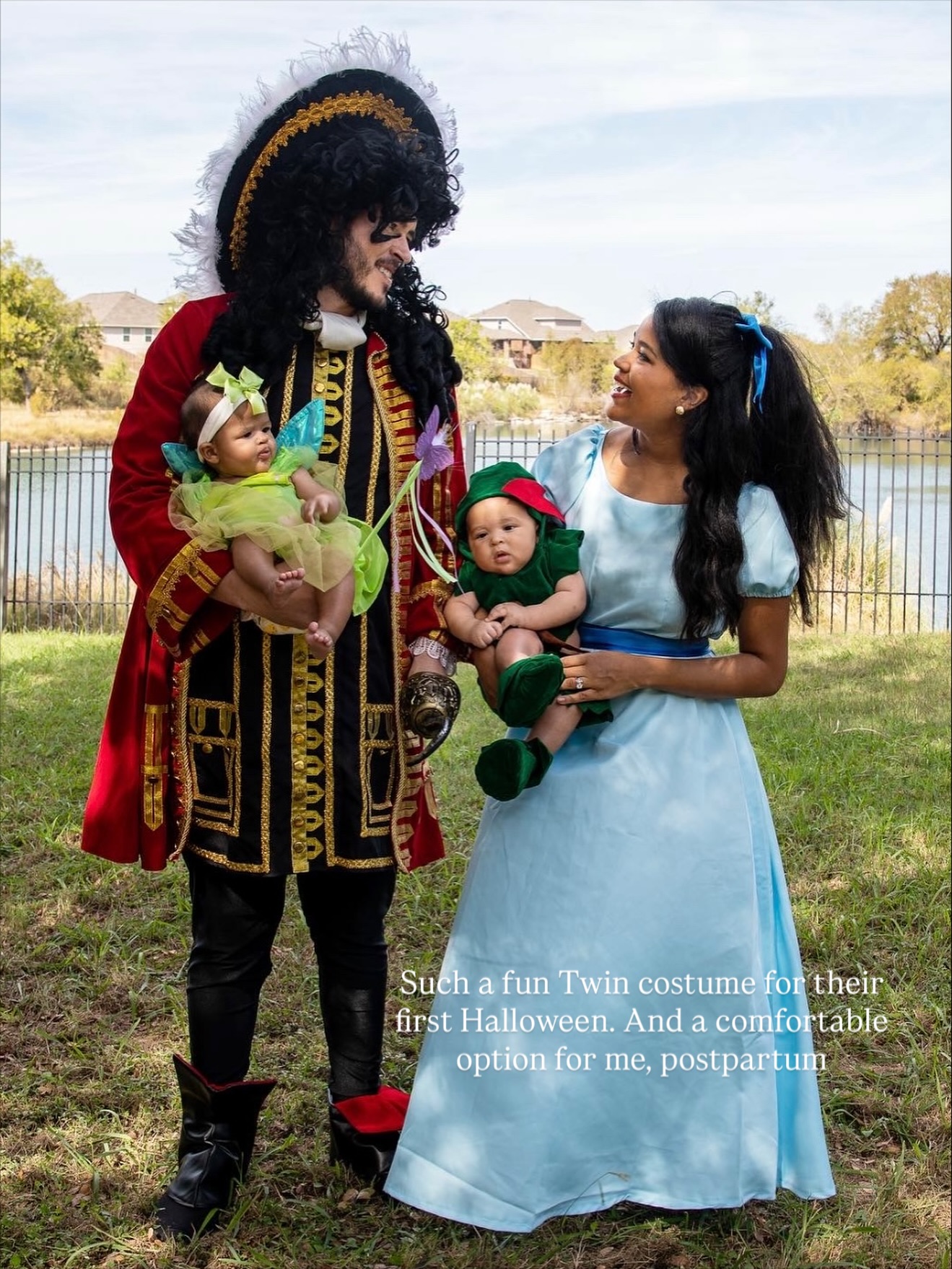 The family dressed as Hook, Wendy, Peter Pan and Tinker Bell beside a lake